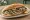 Hamsi Tava Ekmek: an illustration of anchovy, onion and lemon on bread.