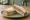 Haslet Sandwich: an illustration of butter, mustard and pickle on white bread.
