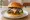 Hēi Sōnglù Hànbǎo (黑松露汉堡): an illustration of beef and cheese on burger bun.