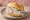 Hering in Sahnesoße Brötchen: an illustration of herring and onion on kaiser roll.