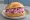 Heringssalat Brötchen: an illustration of herring, apple, onion and mayonnaise on kaiser roll.