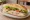 Hindi Sandviç: an illustration of turkey, lettuce, tomato and mayonnaise on bread.