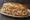 Hoagie: an illustration of ham, salami, provolone, lettuce and more on hoagie roll.