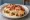 Hot Brown: an illustration of turkey, bacon and tomato on white bread.