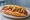 Hot Dog Mexicano: an illustration of sausage, tomato, onion, jalapeño and more on telera roll.