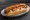Hot Dog Türk Usulü: an illustration of sausage, ketchup and mustard on hot dog bun.