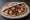 Htapodi se Pita (Χταπόδι): an illustration of octopus, olive oil, lemon, onion and more on pita.