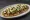 Huarache con Bistec: an illustration of beef, beans, salsa, cheese and more.