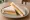 Huǒtuǐ Dàn Sānmíngzhì (火腿蛋三明治): an illustration of ham, egg, mayonnaise and butter on white bread.