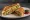 Hyderabadi Sandwich: an illustration of potato, cucumber, tomato, onion and more on white bread.