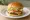 In-N-Out Style Burger: an illustration of beef, american cheese, lettuce, tomato and more on burger bun.
