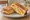 Isaac Toast — Corn Cheese Toast: an illustration of corn, cheese, egg, cabbage and more on white bread.