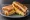 Isaac Toast — Deep Cheese Bacon: an illustration of bacon, cheese, egg, cabbage and more on white bread.