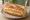 Isaac Toast — French Bread Menu: an illustration of ham, egg, cheese, cabbage and more on baguette.