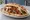 Iskender im Fladenbrot: an illustration of lamb, beef, marinara and yogurt.