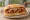 Island Style - Ionian: an illustration of pork on bread.