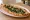 Ispanaklı Pide: an illustration of spinach and onion on pita.