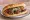 Izgara Köfte Ekmek: an illustration of beef, onion, tomato and parsley on bread.