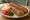 Jachnun (ג'חנון): an illustration of egg, butter and tomato.