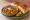 Jain Pav Bhaji: an illustration of tomato, pepper, butter, cilantro and more on bread.