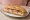 Jambon-Beurre Cornichons: an illustration of ham, butter and pickle on baguette.