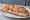 Jambon-Beurre Tradition: an illustration of ham and butter on baguette.