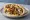 Jerusalem Style: an illustration of chicken, onion, tahini and pickle on pita.