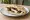 Jibneh w Zaytoun (جبنة وزيتون): an illustration of cheese and olives on pita.