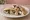 Jibneh w Zaytoun (جبنة وزيتون): an illustration of cheese and olives on pita.