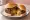 Jucy Lucy: an illustration of beef, american cheese and onion on burger bun.