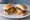 Juicy Lucy: an illustration of beef and american cheese on burger bun.