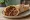 Kıyma Döner: an illustration of beef, onion, tomato and parsley on pita.