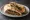 Kafta Mashwiye (كفتة مشوية): an illustration of beef, lamb, onion and parsley on pita.