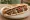 Kafta Sandwich (ساندويش كفتة): an illustration of beef, lamb, parsley, onion and more on pita.