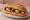 Kahvaltılık Sandviç: an illustration of sucuk, cheese, tomato, cucumber and more on bread.