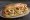 Kalamar Ekmek: an illustration of squid, lettuce, tomato and lemon on bread.