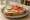 Kanapka Śniadaniowa: an illustration of butter, ham, cheese, tomato and more on bread.
