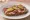 Kanapka z Baleronem: an illustration of butter, mustard and pickle on bread.