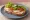 Kanapka z Indykiem: an illustration of butter, turkey, lettuce, tomato and more on bread.