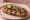 Kanapka z Kabanosy: an illustration of butter, mustard and pickle on bread.