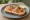 Kanapka z Łososiem: an illustration of butter, salmon, cream cheese, dill and more on bread.