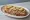 Kanapka z Pasztetem: an illustration of butter, pâté, pickle and onion on bread.