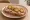 Kanapka z Polędwicą: an illustration of butter, pork, mustard and pickle on bread.