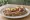 Kanapka z Rosbefem: an illustration of butter, beef, horseradish, mustard and more on bread.