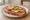 Kanapka z Salami: an illustration of butter, salami, cheese and pickle on bread.