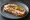 Kanapka z Schabu: an illustration of butter, pork, mustard and pickle on bread.