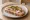 Kanapka z Szynką Gotowaną: an illustration of butter, ham, mustard and pickle on bread.