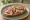 Kanapka z Szynką Wędzoną: an illustration of ham and butter on bread.