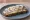 Kanapka ze Śledziem: an illustration of herring, onion and butter on bread.
