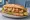Karides Ekmek: an illustration of shrimp, lettuce, tomato, lemon and more on bread.